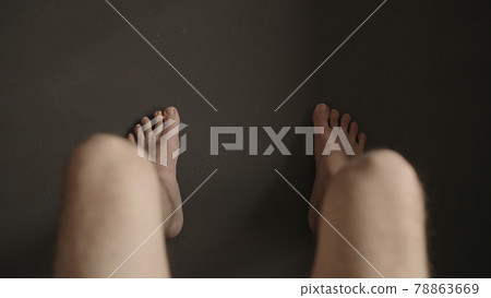 Man sitting with naked legs indoor 78863669