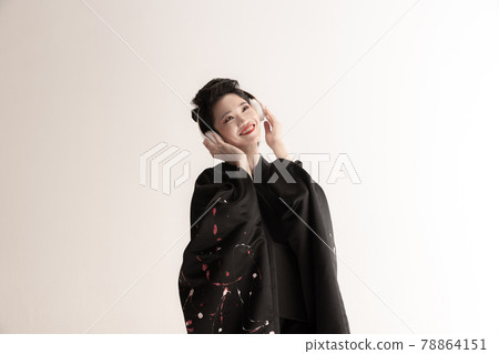 Portrait of young beautiful Japanese, woman in national attire kimono posing isolated over white studio background. Portrait of young beautiful Japanese, woman in national attire kimono posing isolated over white studio background. 78864151