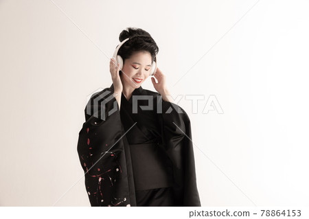 Portrait of young beautiful Japanese, woman in national attire kimono posing isolated over white studio background. Portrait of young beautiful Japanese, woman in national attire kimono posing isolated over white studio background. 78864153