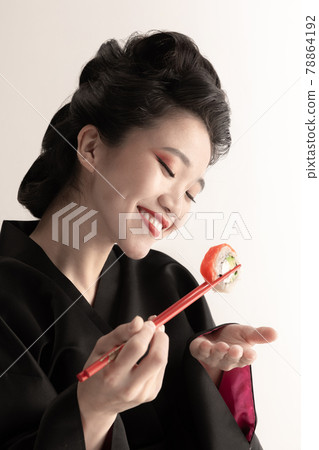 Portrait of young beautiful Japanese, woman in national attire kimono posing isolated over white studio background. Portrait of young beautiful Japanese, woman in national attire kimono posing isolated over white studio background. 78864192