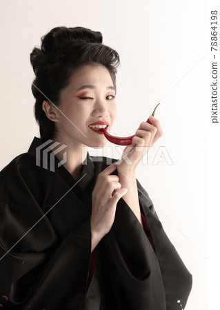 Portrait of young beautiful Japanese, woman in national attire kimono posing isolated over white studio background. Portrait of young beautiful Japanese, woman in national attire kimono posing isolated over white studio background. 78864198
