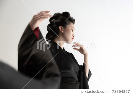 Portrait of young beautiful Japanese, woman in national attire kimono posing isolated over white studio background. Portrait of young beautiful Japanese, woman in national attire kimono posing isolated over white studio background. 78864267