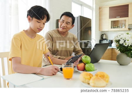 Father Controlling Son Doing Homework Father Controlling Son Doing Homework 78865235