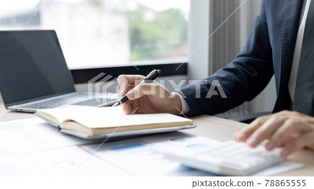 Head of accounting is recording the company's financial growth statistics using graphs as a reference for reviewing and analyzing the results, Taking notes and analyzing data graphs in office. Head of accounting is recording the company's financial growth statistics using graphs as a reference for reviewing and analyzing the results, Taking notes and analyzing data graphs in office. 78865555