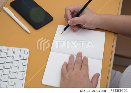 Female Hand Working at home close up shot . Work from home concept  78865601