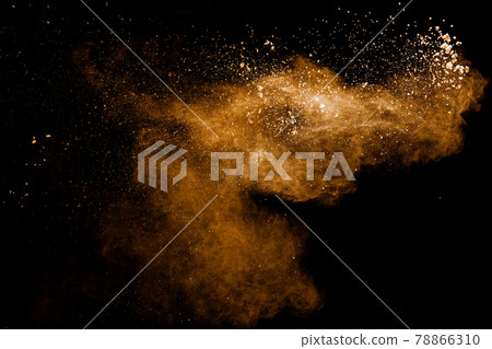 Abstract brown dust explosion on black background.Brown powder splashing. Abstract brown dust explosion on black background.Brown powder splashing. 78866310