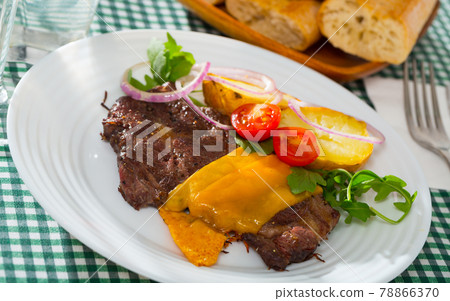 Well done roasted beef steak with cheese 78866370