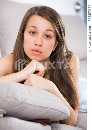 Female is lying stressed and lonely on sofa Female is lying stressed and lonely on sofa 78867673