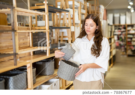 Woman choosing storage basket at household shop 78867677