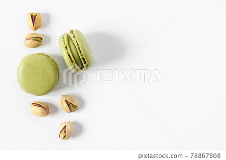 Pistachio macaroons dessert on white background top view. 78867808