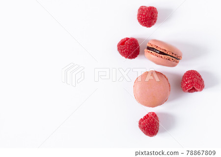 Raspberry macaroons dessert on white background top view. 78867809