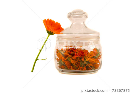 glass jar with calendula dry flowers on white glass jar with calendula dry flowers on white 78867875