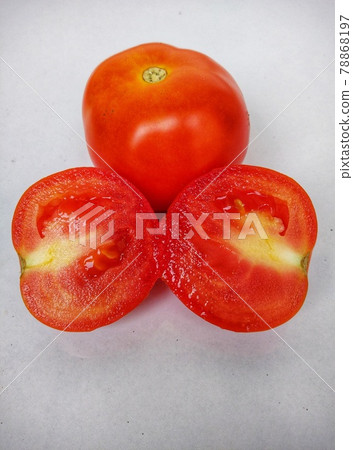Two  red tomatoes and one of cutting halves with white background.  Two  red tomatoes and one of cutting halves with white background.  78868197