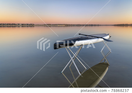 dusk over lake with a paddleboard 78868237