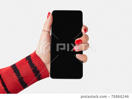 Manicured womans hand holding smartphone with blank screen. 78868246