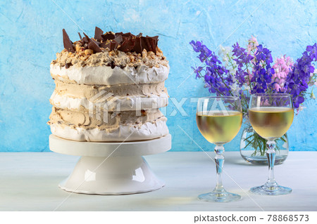 Meringue cake with cream, chocolate and hazelnuts. 78868573