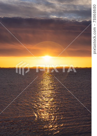 Beautiful View of colorful cloudscape over the ocean during dramatic sunset 78868680