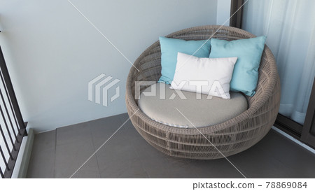 Outdoor beach chair on the hotel room balcony or terrace which made from natural wood called rattan and brown color round shape and look luxury for relaxing or sleeping or for party. Outdoor beach chair on the hotel room balcony or terrace which made from natural wood called rattan and brown color round shape and look luxury for relaxing or sleeping or for party. 78869084