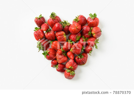 Ugly three ripe organic strawberry on black background. 78870370
