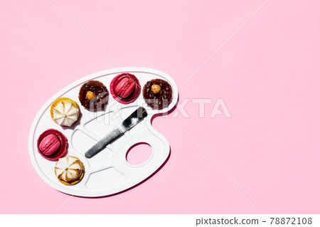 Creative still life of colorful macarons as a form of colors on art palette. Minimal abstract concept. Macarons pastry almond sweet on pink background 78872108