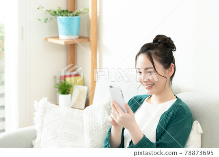 Young woman looking at a smartphone 78873695