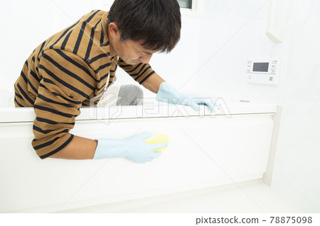 A man cleaning a bath 78875098