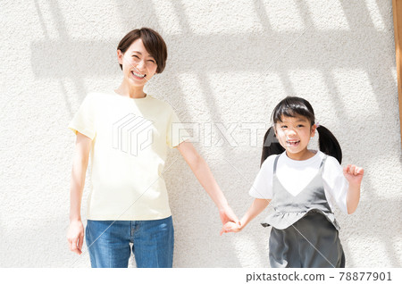 Girl and mother jumping happily while basking in the sun 78877901