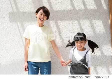 Girl and mother jumping happily while basking in the sun 78877904