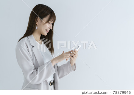Woman using a smartphone Woman using a smartphone 78879946