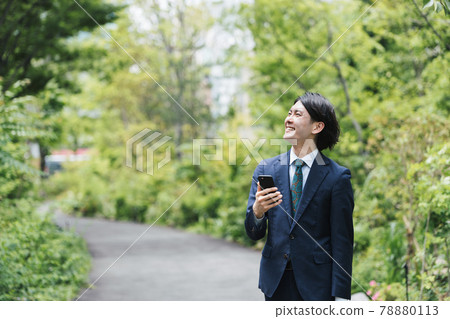 IoT image of a businessman who uses a smartphone while commuting 78880113