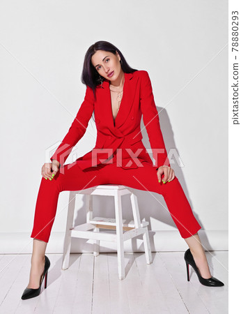 Young self-confident brunette woman in red Young self-confident brunette woman in red 78880293