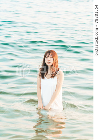 One-piece woman entering the sea 78881354