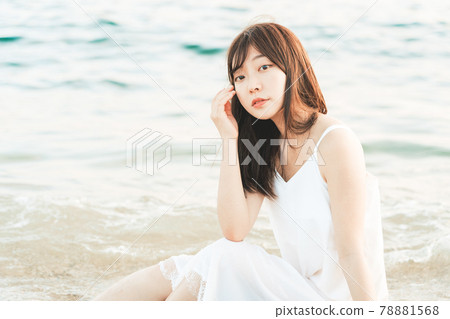 One-piece woman sitting on the beach One-piece woman sitting on the beach 78881568