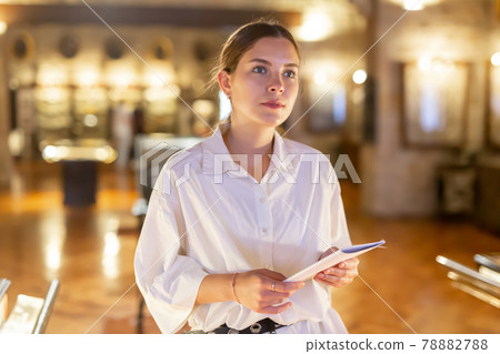 Woman visiting sculpture hall in museum and looking at exhibits 78882788