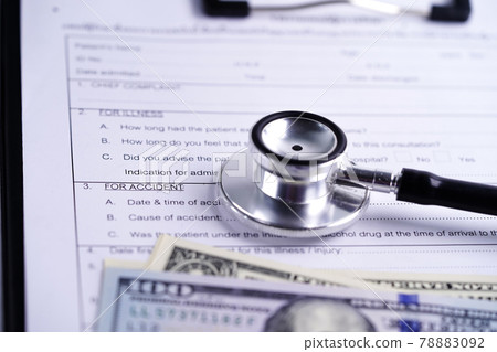 Health insurance accident claim form with stethoscope and US dollar banknotes, Medical concept. Health insurance accident claim form with stethoscope and US dollar banknotes, Medical concept. 78883092