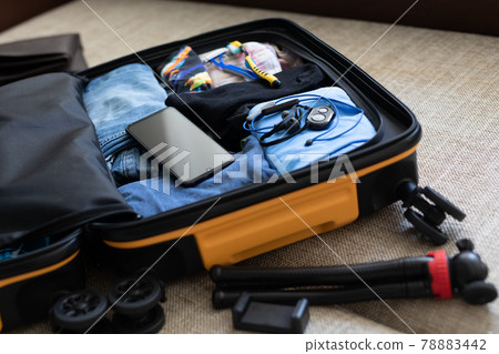 packing a suitcase on a business trip 78883442