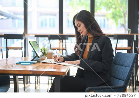 Confident businesswoman concentrate analyzing business data in office. Confident businesswoman concentrate analyzing business data in office. 78884557