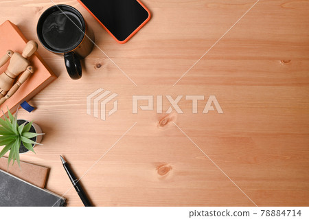 Top view designer workspace with mobile phone, pencil holder, coffee cup and notebook. 78884714