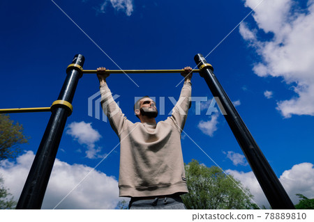 Caucasian sportsman on crossbar during street workout. Healthy lifestyle and street sport concept 78889810