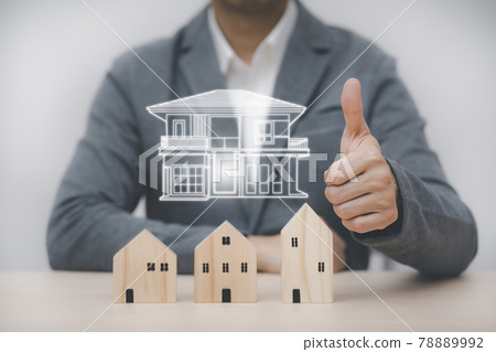 Businessman showing thumbs up mini and wood house model from the model on wood table, Planning buy Real Estate, Planning to buy the property. concept of Choose the best. 78889992