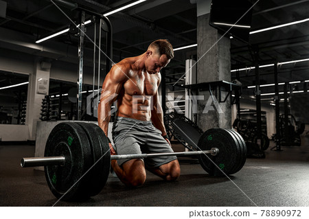 Fatigue from daily workouts, the bodybuilder gathers his spirit before the barbell exercise, sports motivation, overcoming himself. Fatigue from daily workouts, the bodybuilder gathers his spirit before the barbell exercise, sports motivation, overcoming himself. 78890972
