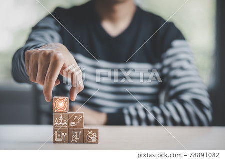 Man hand hold  stack woods block step on table with icon Action plan, Goal and target, success and business target concept, project management, company strategy development. 78891082