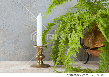 Antique candlestick on concrete background 78891083