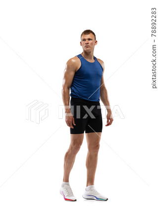 Caucasian professional male athlete, runner standing isolated on white studio background. Muscular, sportive man. Caucasian professional male athlete, runner standing isolated on white studio background. Muscular, sportive man. 78892283