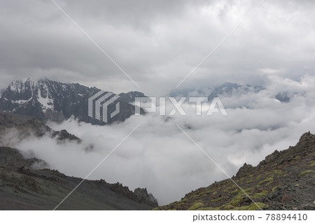 Mountain landscape view in Kyrgyzstan. Rocks, snow and stones in mountain valley view. Mountain panorama. Mountain landscape view in Kyrgyzstan. Rocks, snow and stones in mountain valley view. Mountain panorama. 78894410