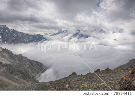 Mountain landscape view in Kyrgyzstan. Rocks, snow and stones in mountain valley view. Mountain panorama. Mountain landscape view in Kyrgyzstan. Rocks, snow and stones in mountain valley view. Mountain panorama. 78894411