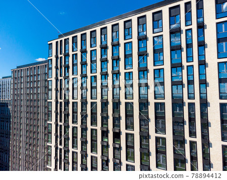 Modern building with windows and balconies Modern building with windows and balconies 78894412