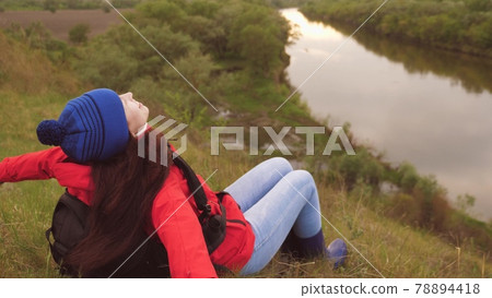 The girl traveler sits high on the mountain. Conquer new places. Active holiday weekend. Free woman tourist looking for adventure in life. The woman is alone. Pandemic The girl traveler sits high on the mountain. Conquer new places. Active holiday weekend. Free woman tourist looking for adventure in life. The woman is alone. Pandemic 78894418