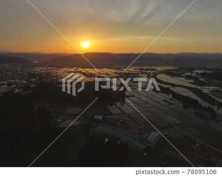 Sunset reflected in rice fields in Uonuma City 78895106