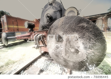 Abstract wide-angle photograph with a surreal large appearing buffer of a historical steam locomotive in the foreground. Abstract wide-angle photograph with a surreal large appearing buffer of a historical steam locomotive in the foreground. 78896445